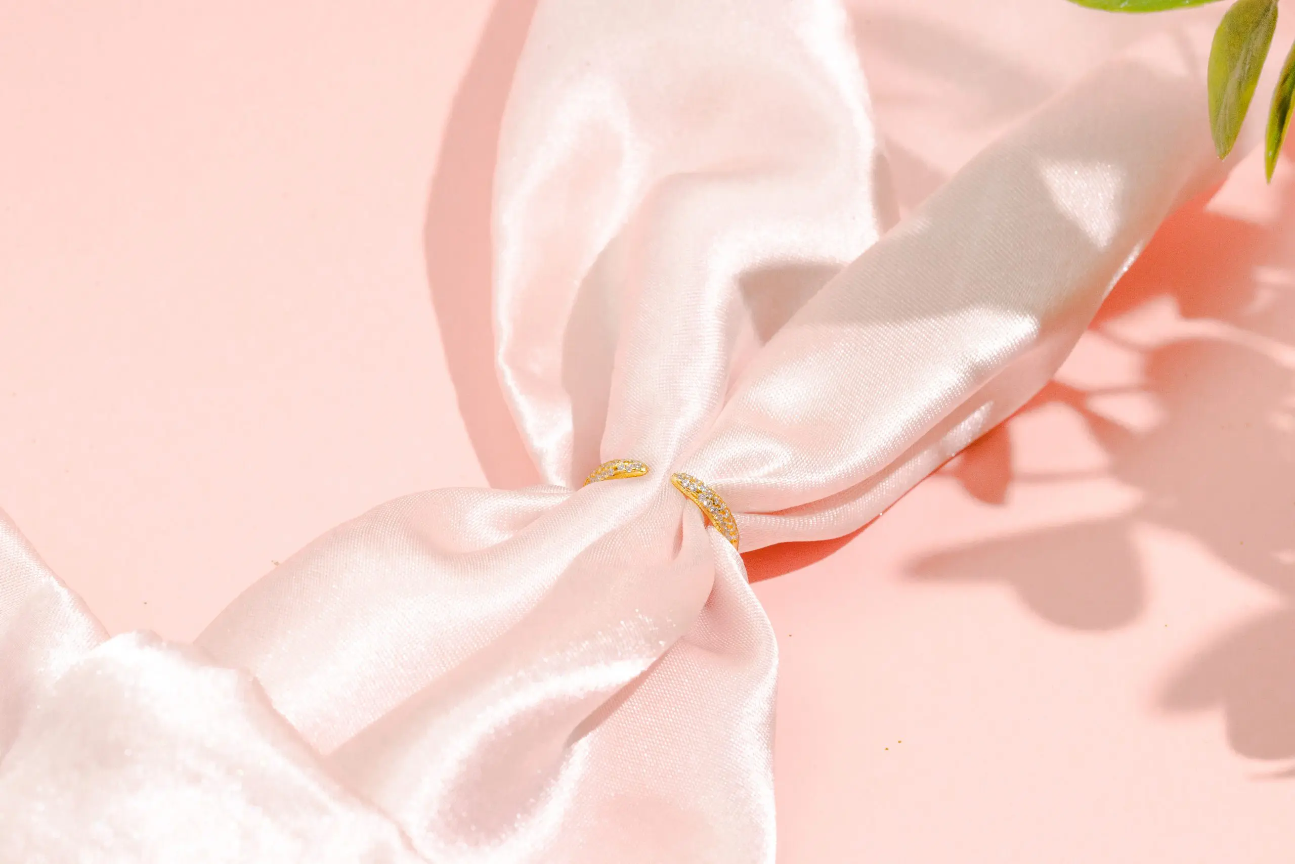 still like jewelery product photography services by danielle deangelis. gold rings photographed on a pink background with a white riser